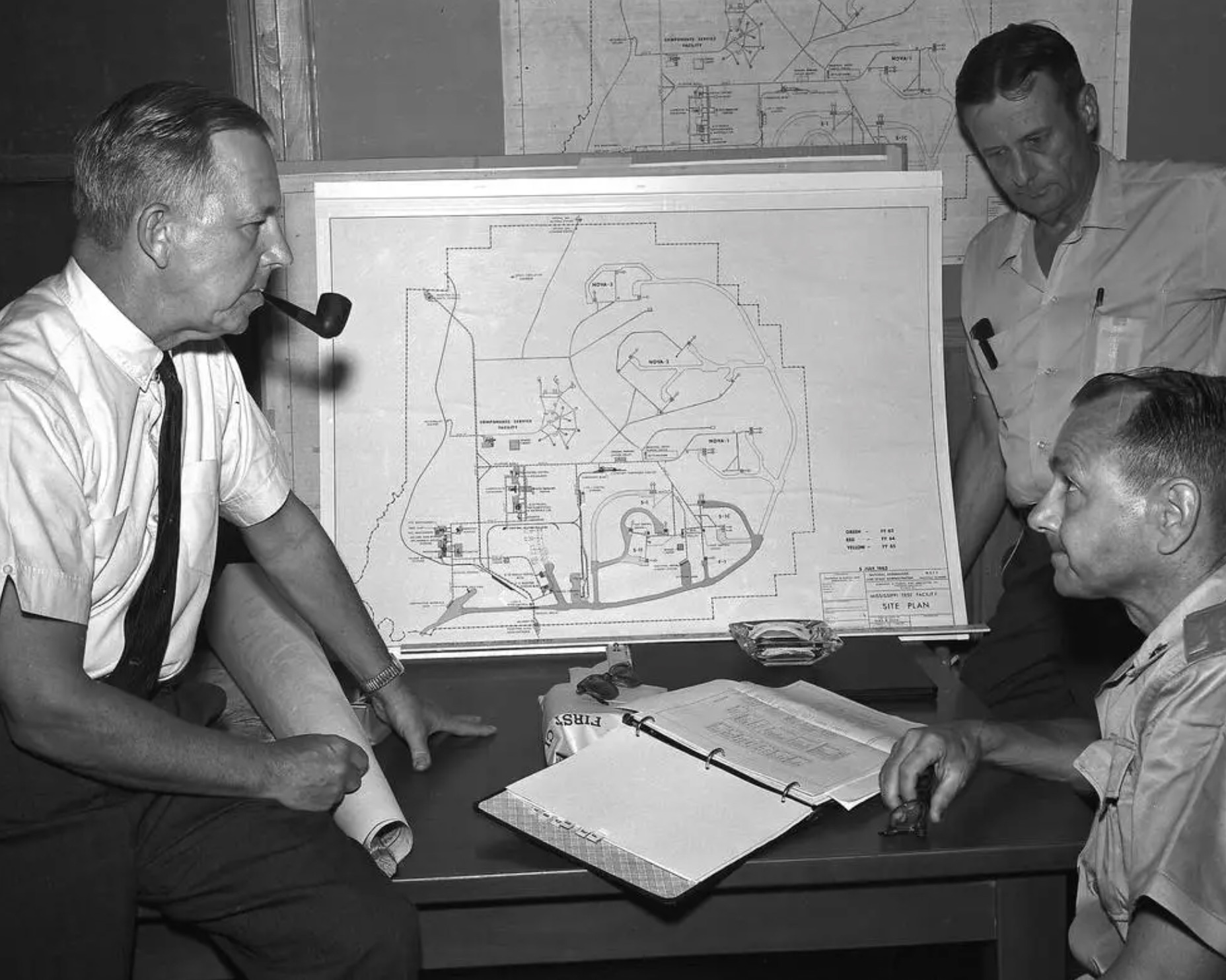 Looking over blueprints for the Stennis Space Center